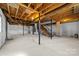 Unfinished basement with exposed wooden beams and concrete floor at 1251 Magnolia St, Albemarle, NC 28001