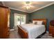 Cozy bedroom with wooden bed frame and large window overlooking backyard at 3905 Granite St, Terrell, NC 28682