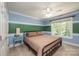 Spacious bedroom with light blue and green walls, featuring a large bed and window at 3905 Granite St, Terrell, NC 28682