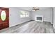 Front entry with wood door and gray walls, wood-look vinyl flooring at 1613 Ohenry Ln, Fort Mill, SC 29708