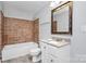 Updated bathroom with granite vanity and brown tile shower/tub combo at 1613 Ohenry Ln, Fort Mill, SC 29708