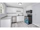 Modern kitchen with white cabinets, granite counters, and stainless steel appliances at 1613 Ohenry Ln, Fort Mill, SC 29708