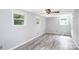 Spacious bedroom with wood-look floors and multiple windows at 1613 Ohenry Ln, Fort Mill, SC 29708