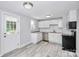 Updated kitchen with white cabinets, granite countertops and stainless steel appliances at 1613 Ohenry Ln, Fort Mill, SC 29708
