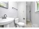 Clean bathroom with pedestal sink, toilet and shower at 1613 Ohenry Ln, Fort Mill, SC 29708