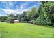 House exterior showcasing a large lawn and trees at 1613 Ohenry Ln, Fort Mill, SC 29708