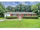 Brick ranch house with a well-maintained lawn and landscaping at 1613 Ohenry Ln, Fort Mill, SC 29708