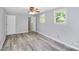 Bright bedroom with wood-look floors and ceiling fan at 1613 Ohenry Ln, Fort Mill, SC 29708
