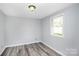 Simple bedroom with wood-look floors and one window at 1613 Ohenry Ln, Fort Mill, SC 29708