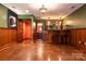 Finished basement with bar area, stained concrete floor, and wood paneling at 2101 Congress Ct, Kannapolis, NC 28083