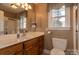 Bathroom with wooden cabinets, toilet, sink, and shower at 2101 Congress Ct, Kannapolis, NC 28083