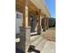 Covered front porch with brick columns and ceiling fan at 1018 Cross Creek Dr, Oakboro, NC 28129