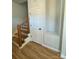 Hardwood floors, staircase, and storage closet in entryway at 1018 Cross Creek Dr, Oakboro, NC 28129