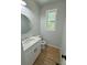 Clean bathroom with white vanity, quartz countertop, and a window at 1018 Cross Creek Dr, Oakboro, NC 28129