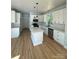 Bright kitchen boasts white cabinets, an island, and stainless steel appliances at 1018 Cross Creek Dr, Oakboro, NC 28129