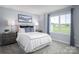Cozy bedroom with a comfortable bed and large window at 107 Jameson Park Dr # 3, Troutman, NC 28166