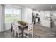 Eat-in kitchen with a dining table and view into the living room at 107 Jameson Park Dr # 3, Troutman, NC 28166