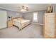 Bedroom with light gray walls, a large bed, and wood dresser at 846 Windy Oaks Way, Lancaster, SC 29720