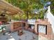 Outdoor kitchen with built-in grill, refrigerator, and brick counter at 846 Windy Oaks Way, Lancaster, SC 29720