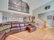 Open living room with hardwood floors, a large sectional sofa, and high ceilings at 846 Windy Oaks Way, Lancaster, SC 29720