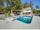 Inviting in-ground pool with a diving board, pergola, and brick fireplace at 846 Windy Oaks Way, Lancaster, SC 29720