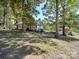 Picturesque home exterior showcasing a sunroom and large backyard at 846 Windy Oaks Way, Lancaster, SC 29720