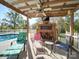 Outdoor brick fireplace and pergola with seating area near the pool at 846 Windy Oaks Way, Lancaster, SC 29720