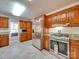 Kitchen boasts stainless steel appliances and ample wood cabinetry at 846 Windy Oaks Way, Lancaster, SC 29720