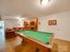 Finished basement with a pool table and brick fireplace at 846 Windy Oaks Way, Lancaster, SC 29720