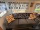 Relaxing living room featuring a gray couch and blue armchair at 134 Dove Ln, New London, NC 28127