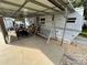 Covered patio with golf cart, seating, and swing at 134 Dove Ln, New London, NC 28127