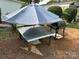 Wooden patio table with umbrella and gas grill at 134 Dove Ln, New London, NC 28127
