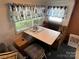Small dining area with built-in seating and a table at 134 Dove Ln, New London, NC 28127