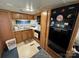 Galley kitchen with wood cabinets, full-size refrigerator, and range at 134 Dove Ln, New London, NC 28127