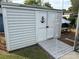 White storage shed with a wooden ramp and nautical decor at 134 Dove Ln, New London, NC 28127