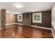 Living room with hardwood floors, stone fireplace, and large windows at 4108 Scarlet St, Matthews, NC 28104