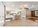 Kitchen and dining area with hardwood floors and a stone accent wall at 4108 Scarlet St, Matthews, NC 28104