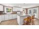 Bright kitchen with white cabinets, granite island, and tile flooring at 4108 Scarlet St, Matthews, NC 28104