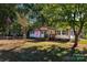 Ranch home with a well-maintained lawn and mature trees at 4108 Scarlet St, Matthews, NC 28104