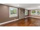 Living room showcasing hardwood floors and a stone feature wall at 4108 Scarlet St, Matthews, NC 28104