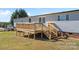 Elevated wooden deck with stairs leading to the yard at 1221 Blake Dr, Mount Holly, NC 28120