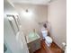 Small bathroom with glass sink, toilet and a towel rack at 3018 Castlebrook Dr, Monroe, NC 28112