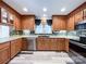 Spacious kitchen with wood cabinets, stainless steel appliances and vinyl flooring at 3018 Castlebrook Dr, Monroe, NC 28112