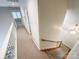 Upstairs hallway with carpeted floors and staircase at 3018 Castlebrook Dr, Monroe, NC 28112