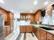 Spacious kitchen with wood cabinets, stainless steel appliances and vinyl flooring at 3018 Castlebrook Dr, Monroe, NC 28112