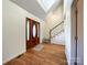 Bright entryway with hardwood floors, staircase, and double doors at 3018 Castlebrook Dr, Monroe, NC 28112