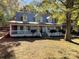 Two-story home with gray siding, white trim, and a porch at 3018 Castlebrook Dr, Monroe, NC 28112