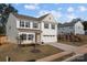 Two-story house with beige vinyl siding, gray trim, and a two-car garage at 2680 Andes Dr, Statesville, NC 28625