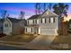 Two story tan house with a two car garage and front yard at 2680 Andes Dr, Statesville, NC 28625
