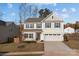 Two-story house with beige vinyl siding, gray trim, and a two-car garage at 2680 Andes Dr, Statesville, NC 28625